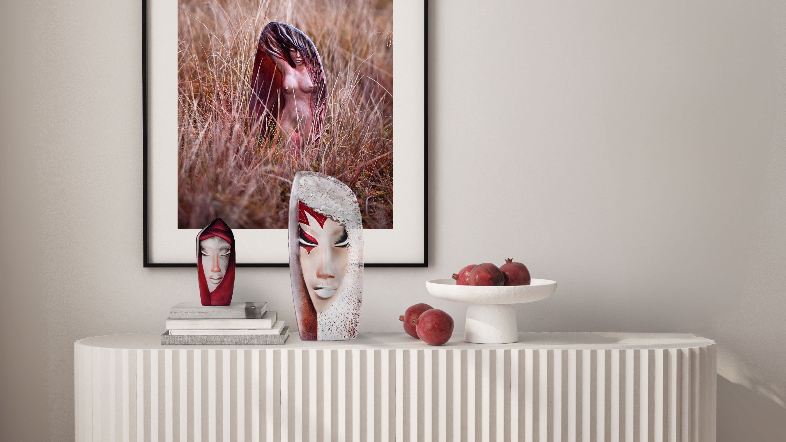 Maleras Batzeba and Mystiqua glass sculptures and a framed artwork on a neutral wall.