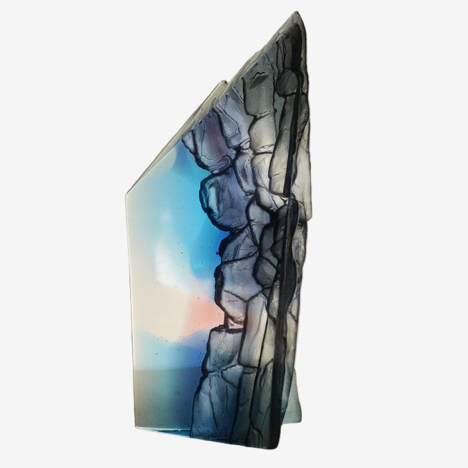 Glass sculpture with abstract design on a plain background