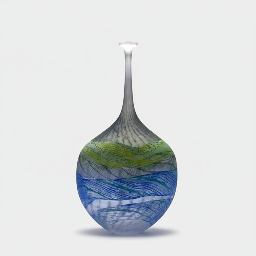 Blue and green glass sculpture in a minimalistic setting