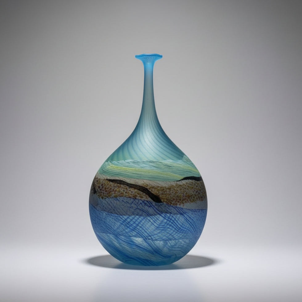 Blue glass vase with swirling patterns on a white background