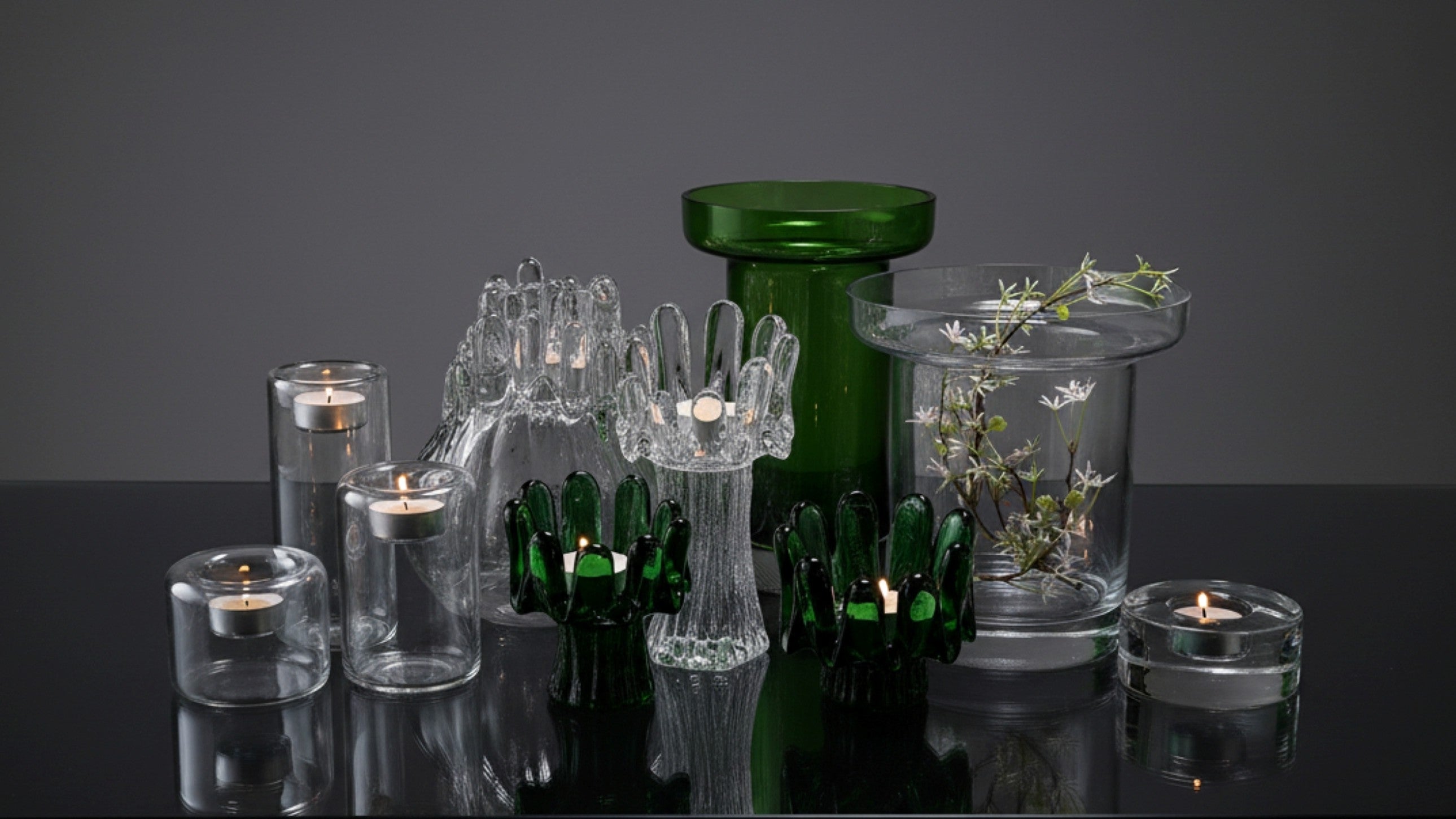 Lifestyle mix - Kosta Boda glass mix lifestyle collection of dSunflower glass candle holders and Limelight vessels
