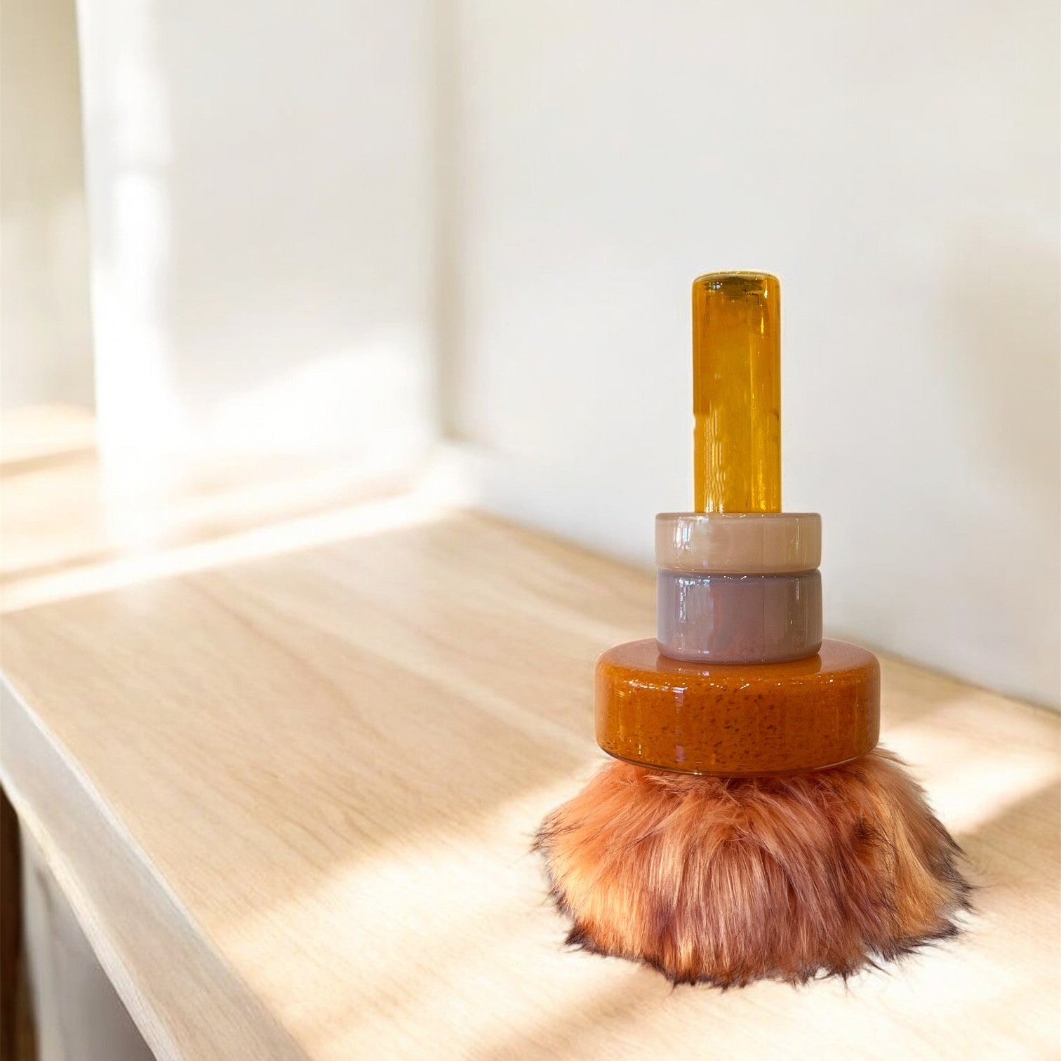 modern Orange glass vase /object on a wooden surface