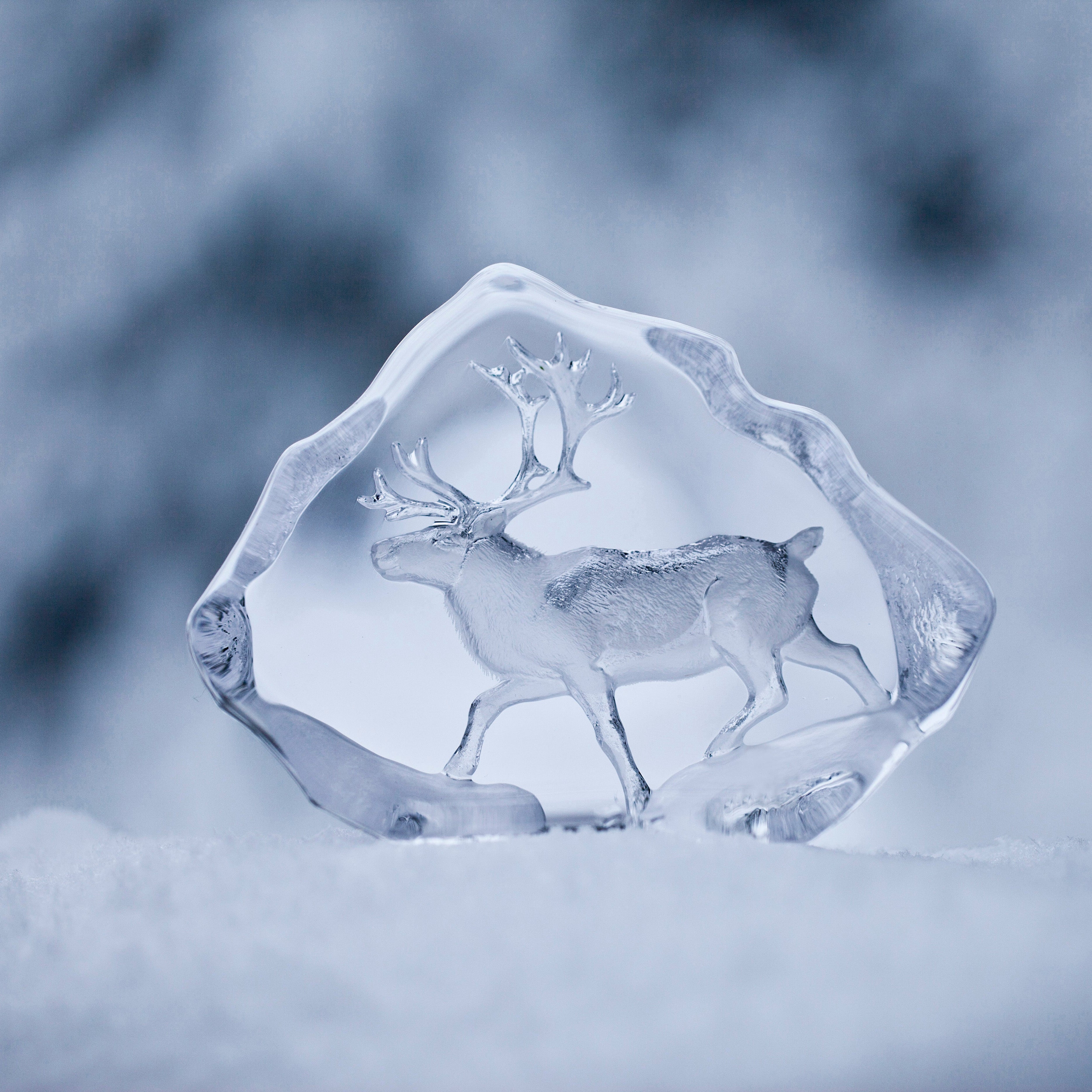 Ice sculpture of two deer in a snowy landscape