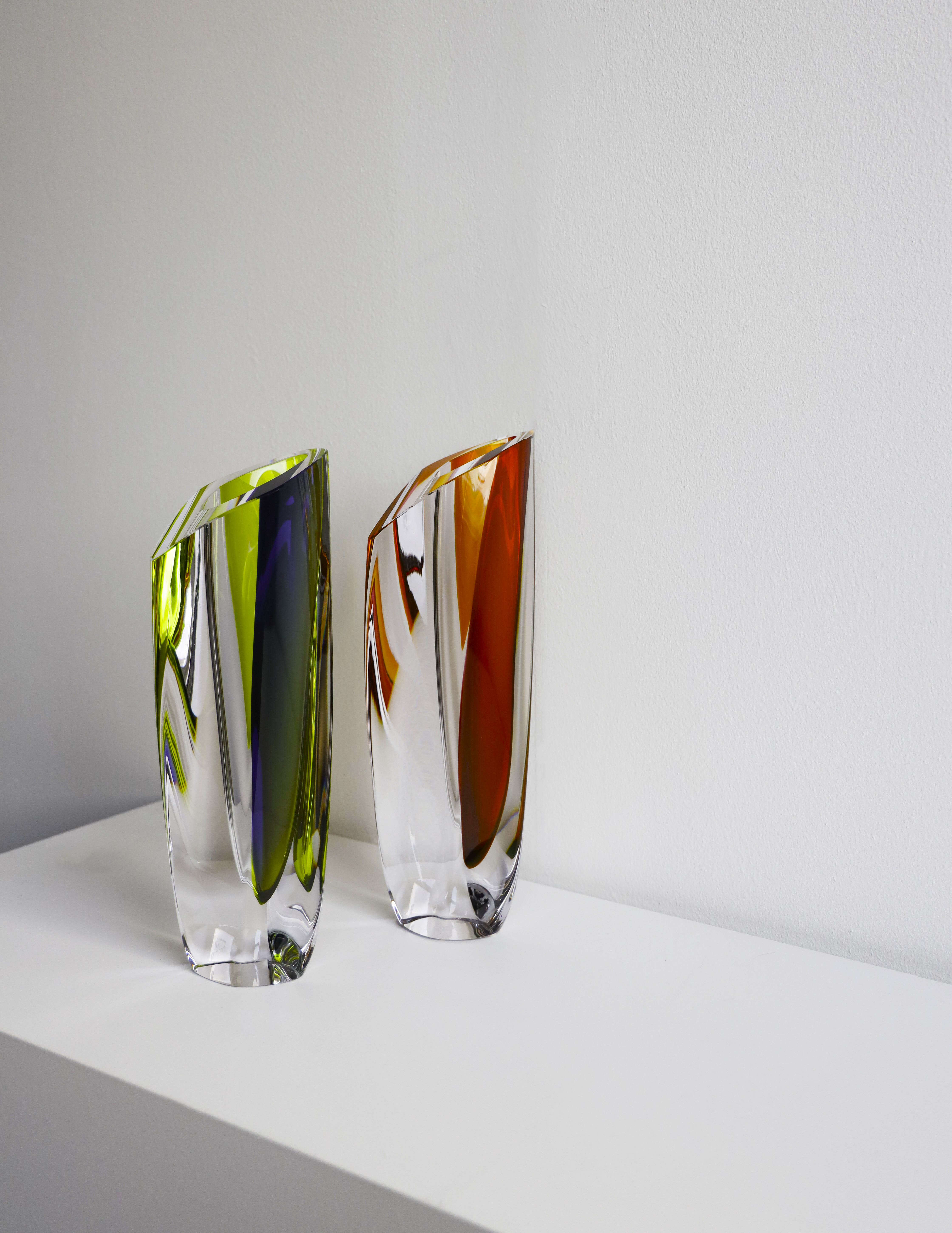 Kosta Boda Saraband glass vase. Two colourful glass vases on a white surface with a light grey background
