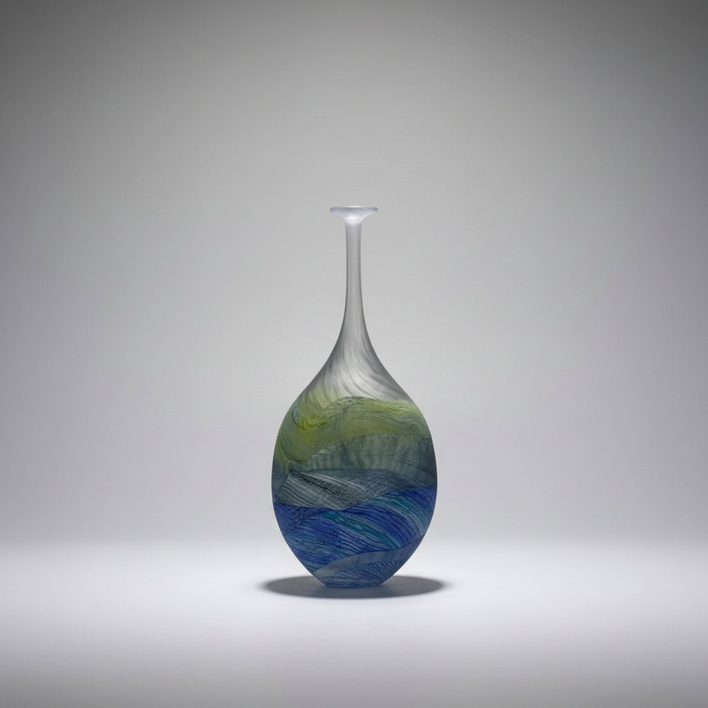 Thomas Petit flattened flask on a white surface with a neutral background