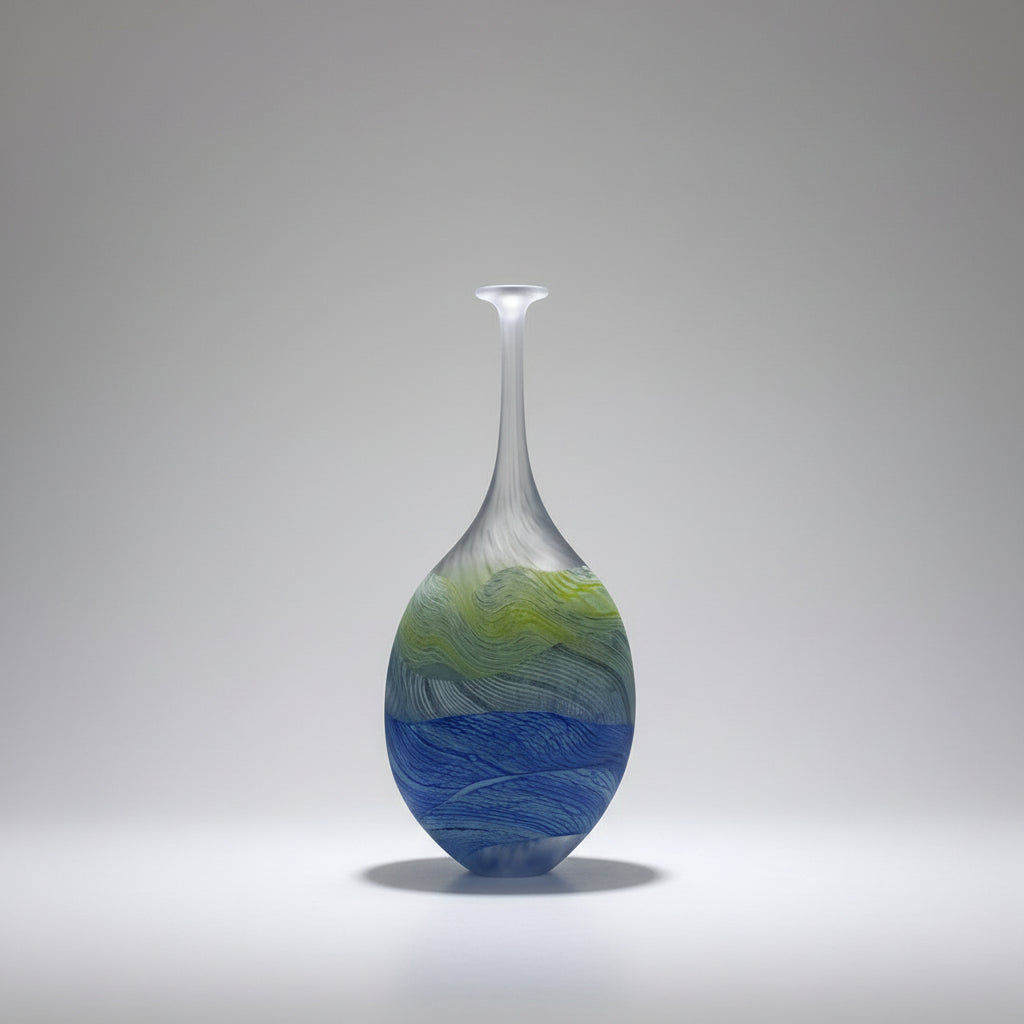 Decorative glass vase with blue and green patterns on a white background