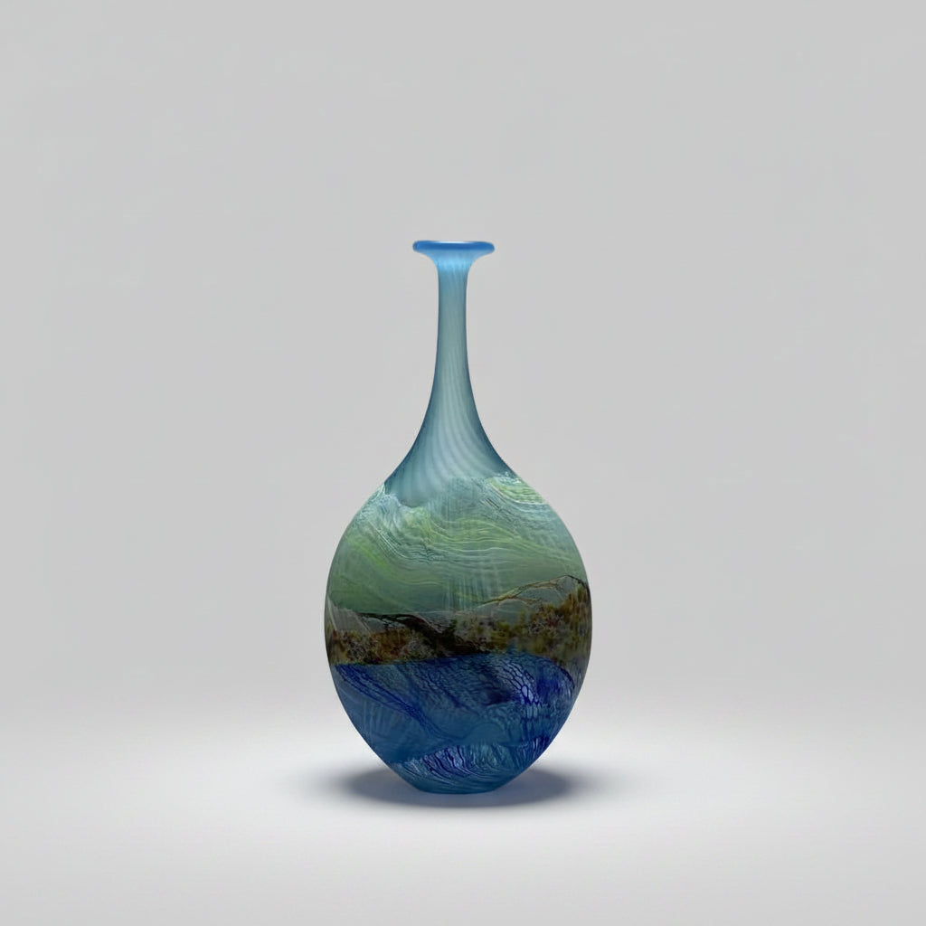 Blue glass vase with marbled design on a white background