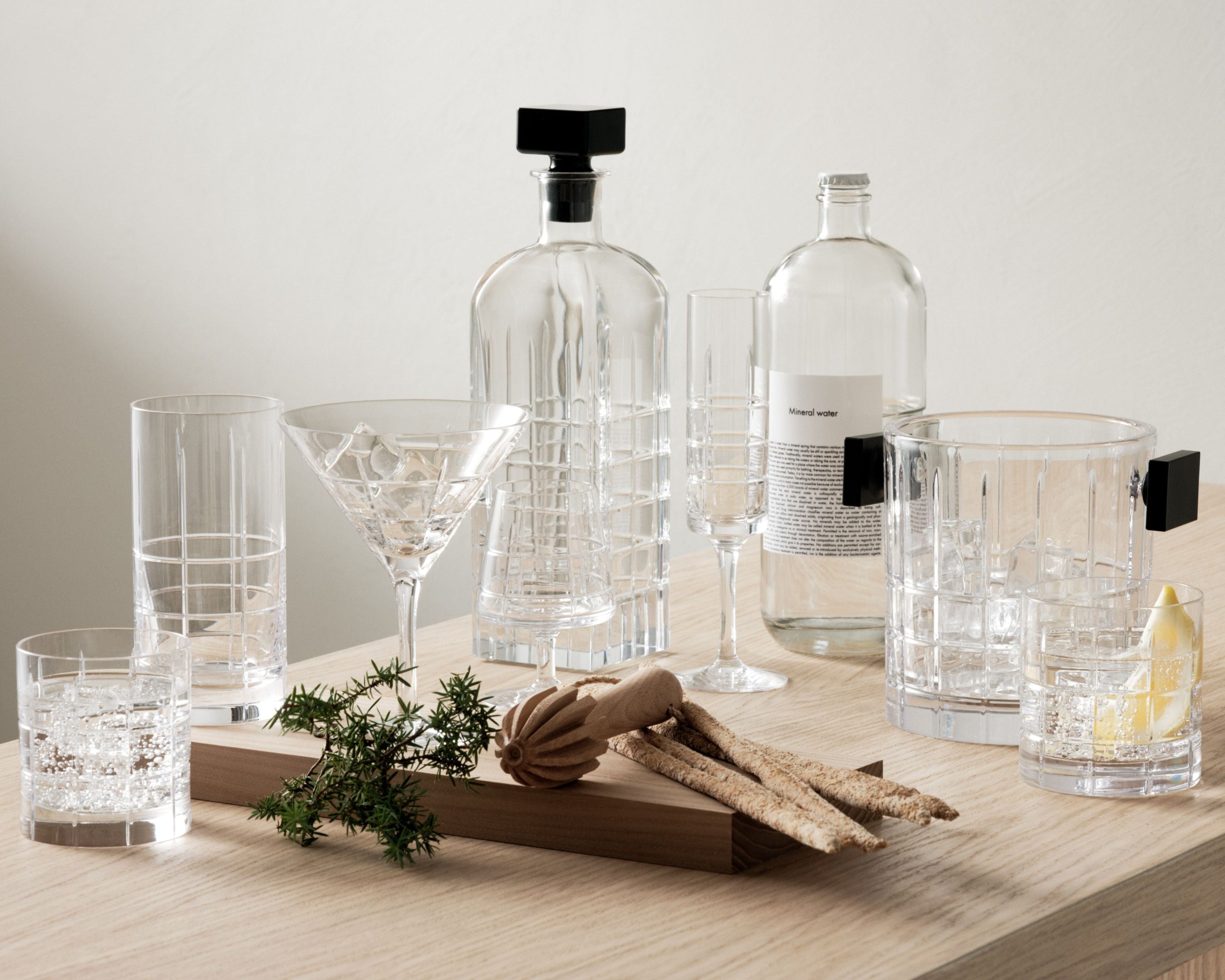 Set of Orrefors glasses including decanter and glasses on a wooden surface with a neutral background