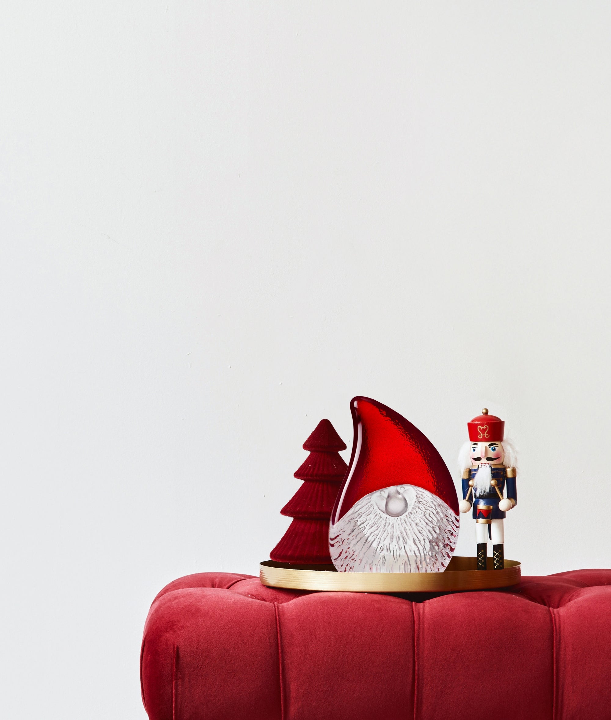 Christmas Santa and nutcracker on a red surface with a white background
