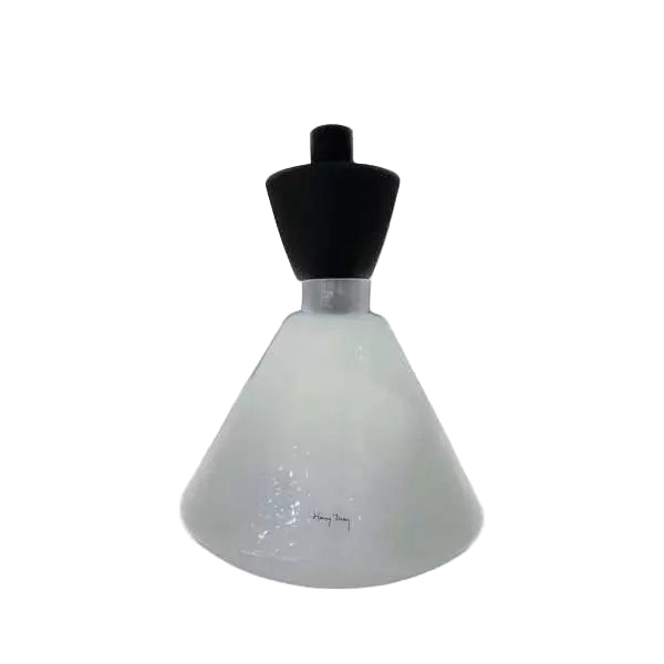White lampshade on a black mannequin stand against a white background