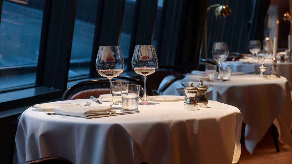 Frantzen wine glasses and cutlery in a restaurant setting.