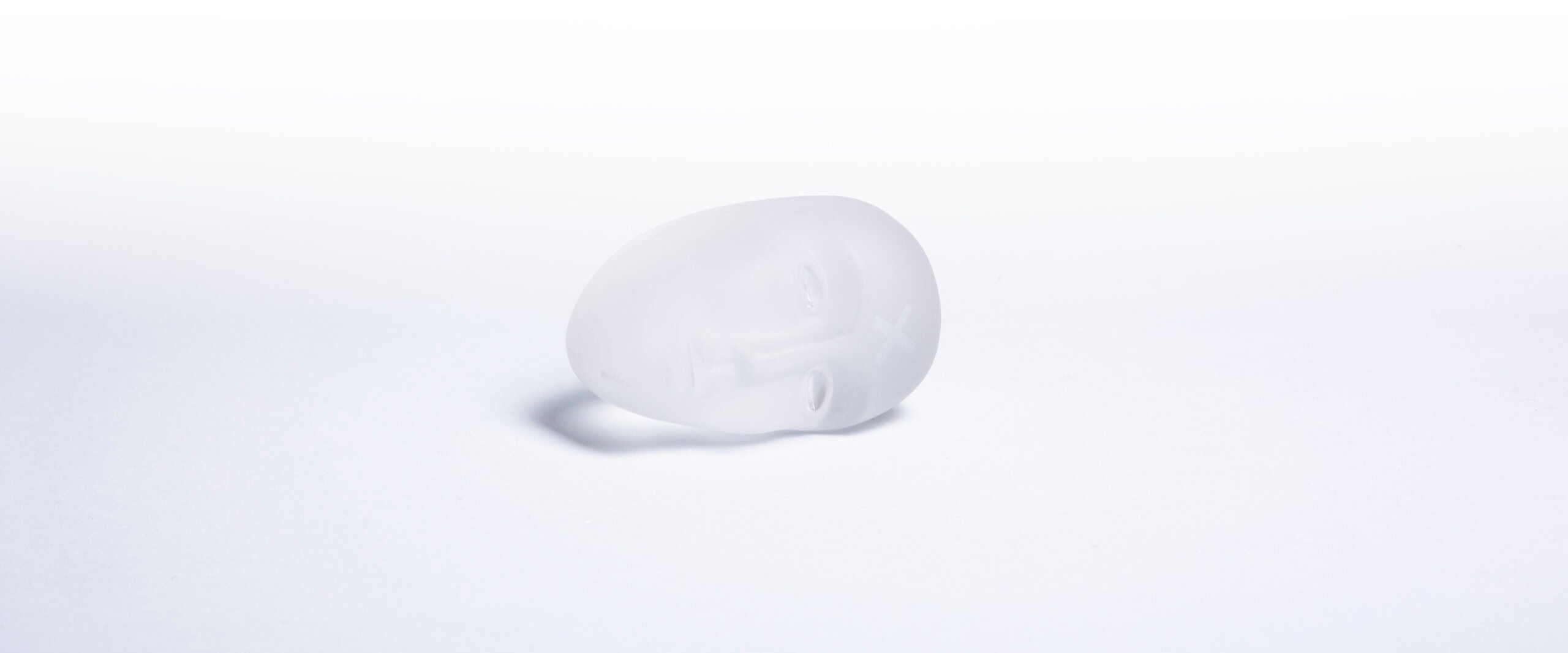 White spherical object on a light gray background