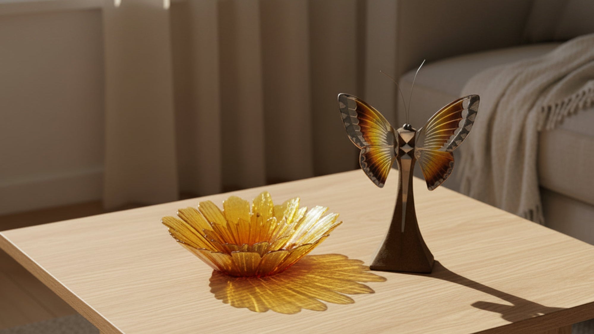 A decorative yellow flower-shaped bowl with a dark brown pedestal stand and a butterfly sculpture beside it, photographed against a neutral gray studio background.