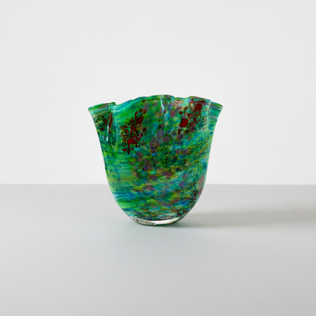 Multicolored glass vase on a white background