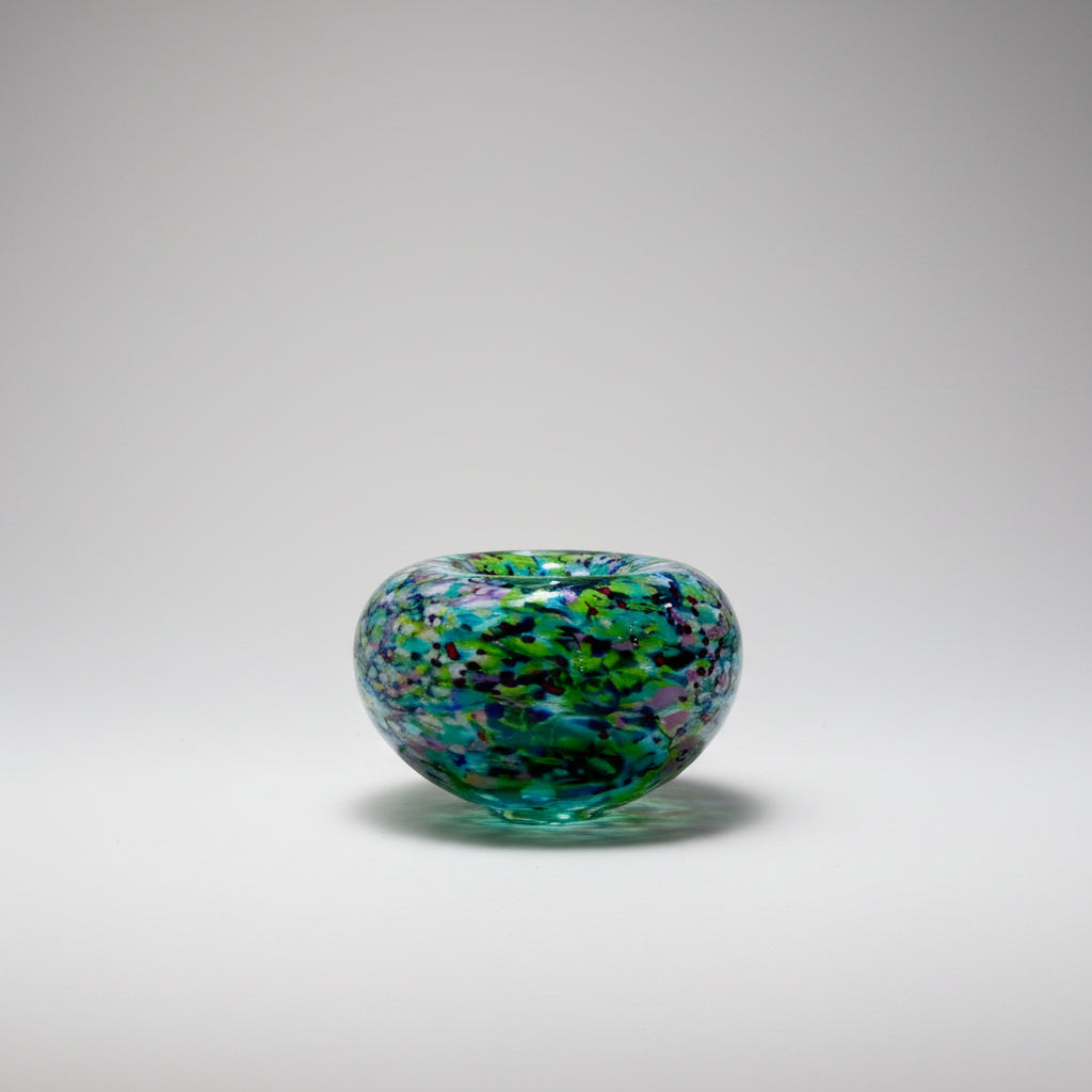 Peter Layton's Monet multicolored glass bowl on a white surface with a neutral background