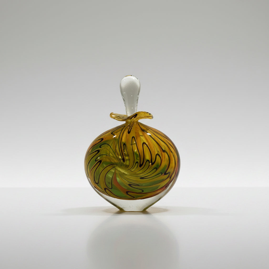 Decorative glass bottle with colorful swirl design on a white surface.