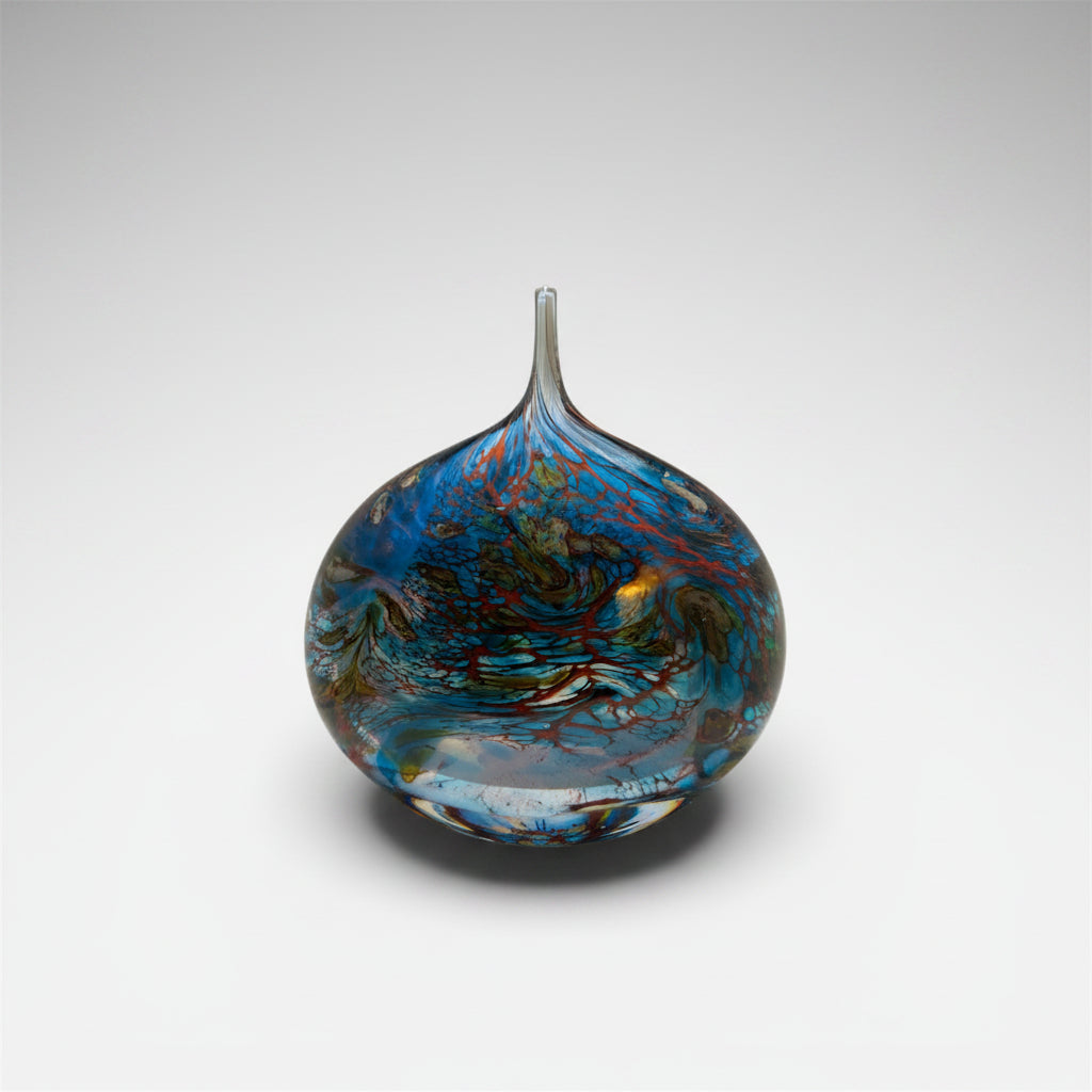 Decorative glass vase with blue and brown patterns on a white background