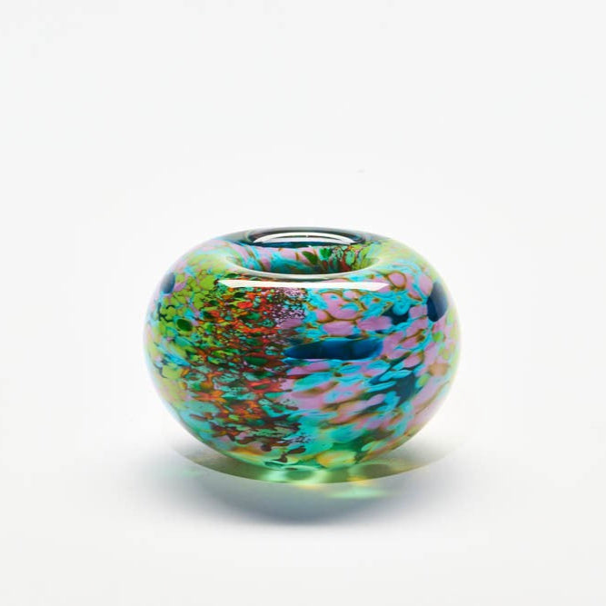 Multicolored glass bead on a white background