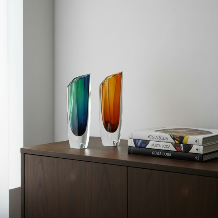 Kosta Boda Saraband glass vase.  Two colourful glass vases on a white surface with a light grey background