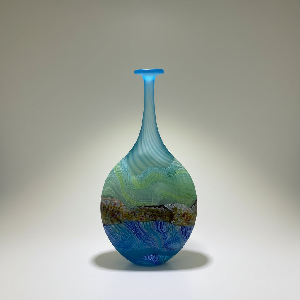 Decorative glass vase with blue and green patterns in a white box