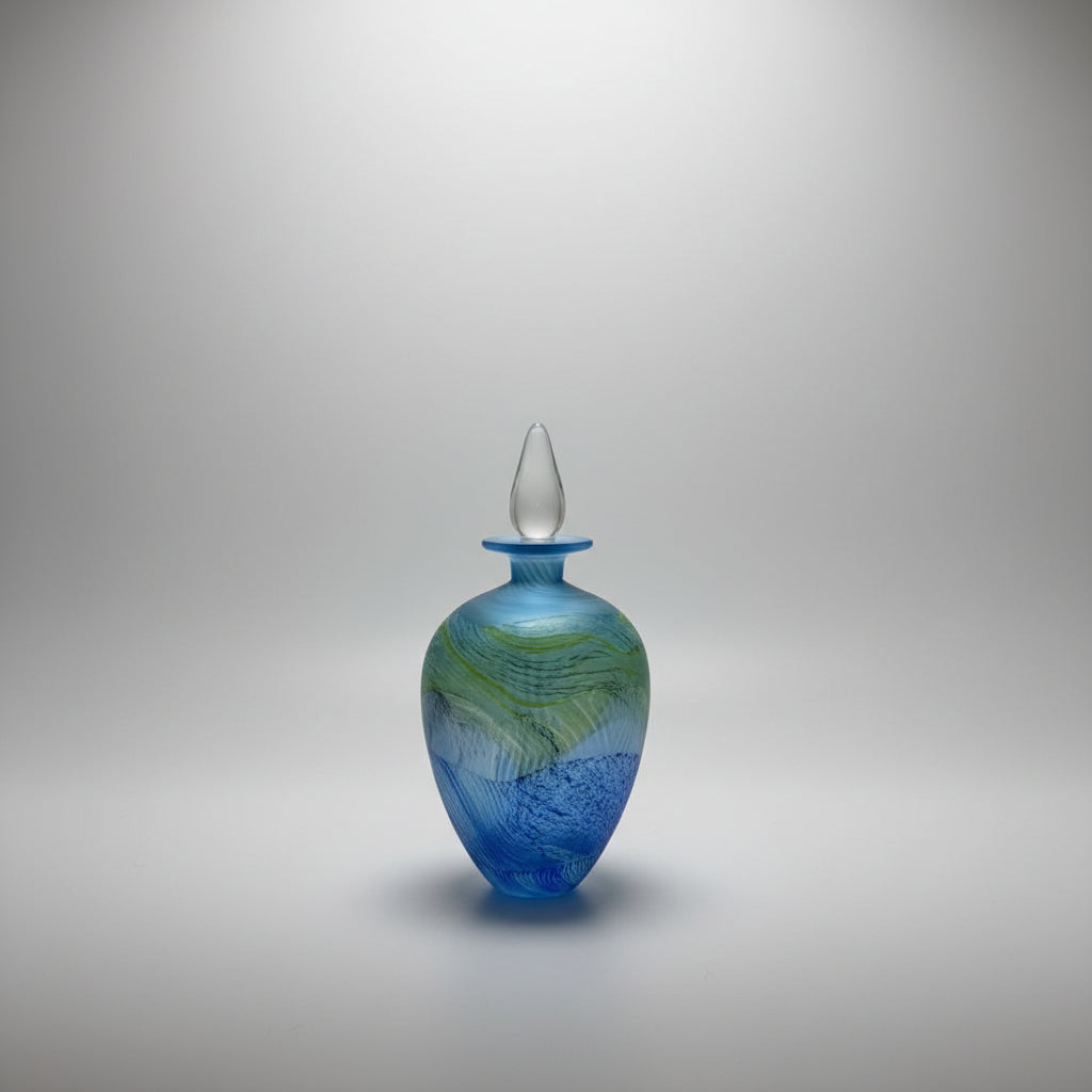 Thomas Petit Sea Shore Blue glass vase with a white stopper on a white platform 
