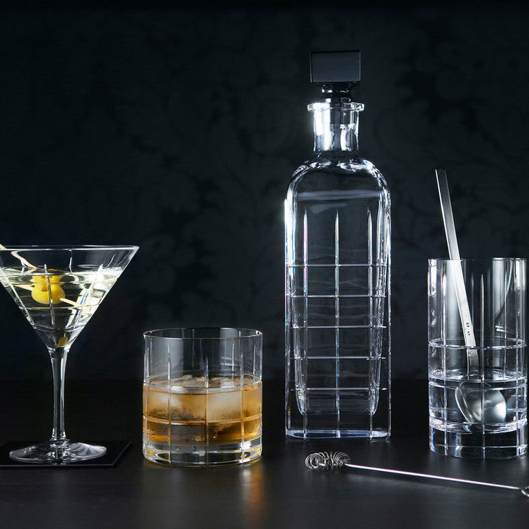 Orrefors glass decanter, glasses with drinks on a dark background