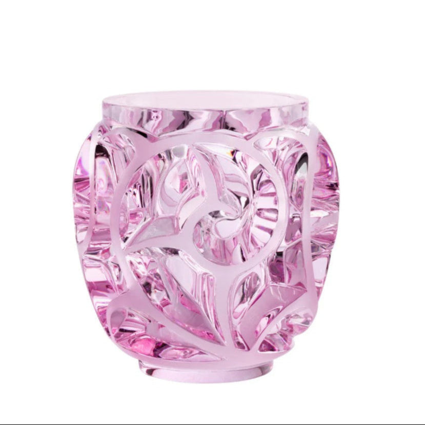 Pink crystal vase with intricate design on a white background