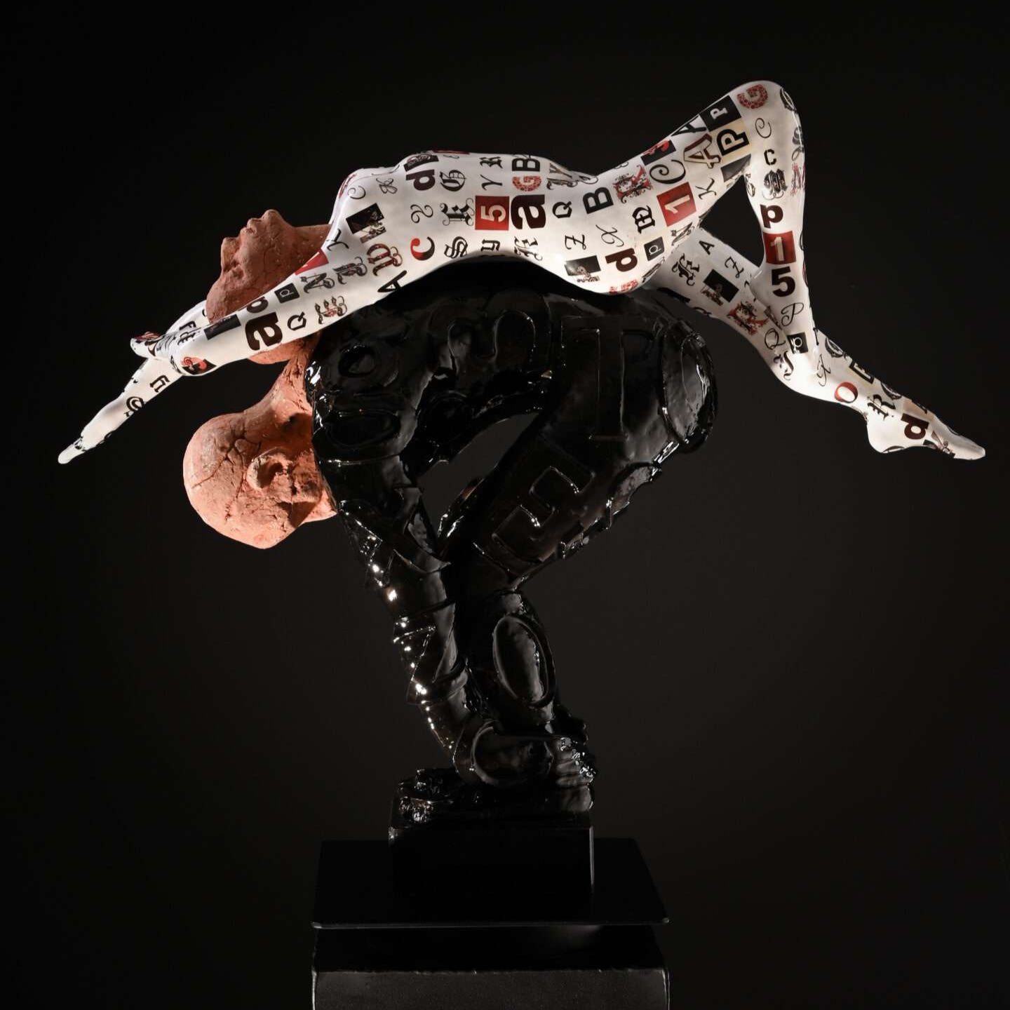 A ceramic sculpture depicting a figure with a stylized, rough texture and patterned garments, standing on a black base against a dark background.