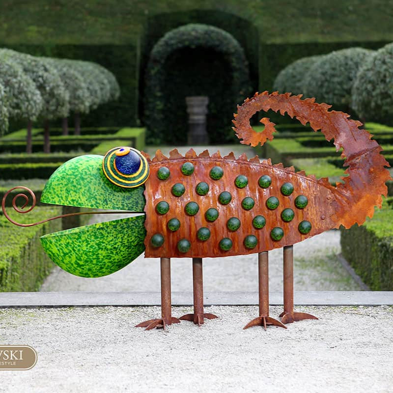 Metallic sculpture of a chameleon in a garden setting with 'BOROWSKI' branding.