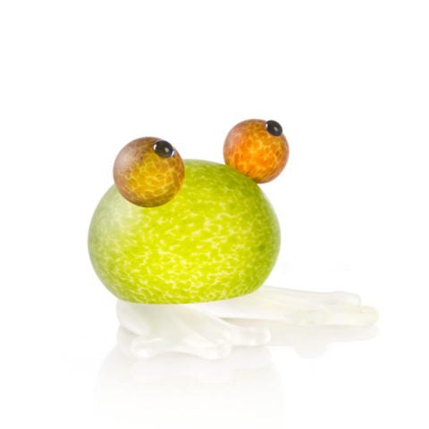 A green frog paperweight with orange and black eyes on a white background