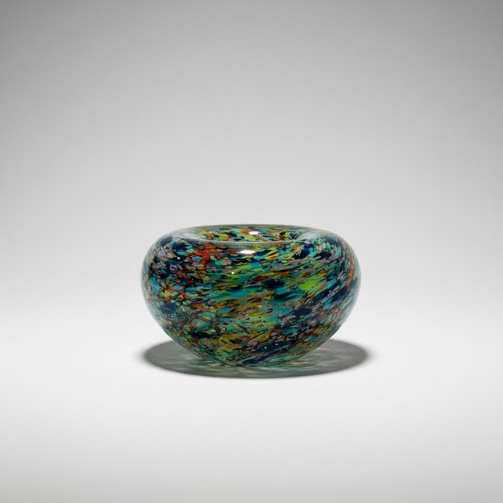 Multicolored glass bowl on a white background